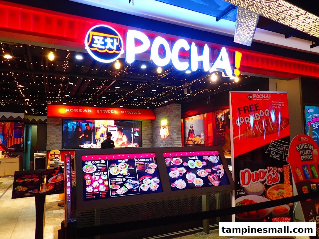 The vibrant red and neon-lit storefront of POCHA! Korean Street Dining, featuring digital menu displays and promotional banners.
