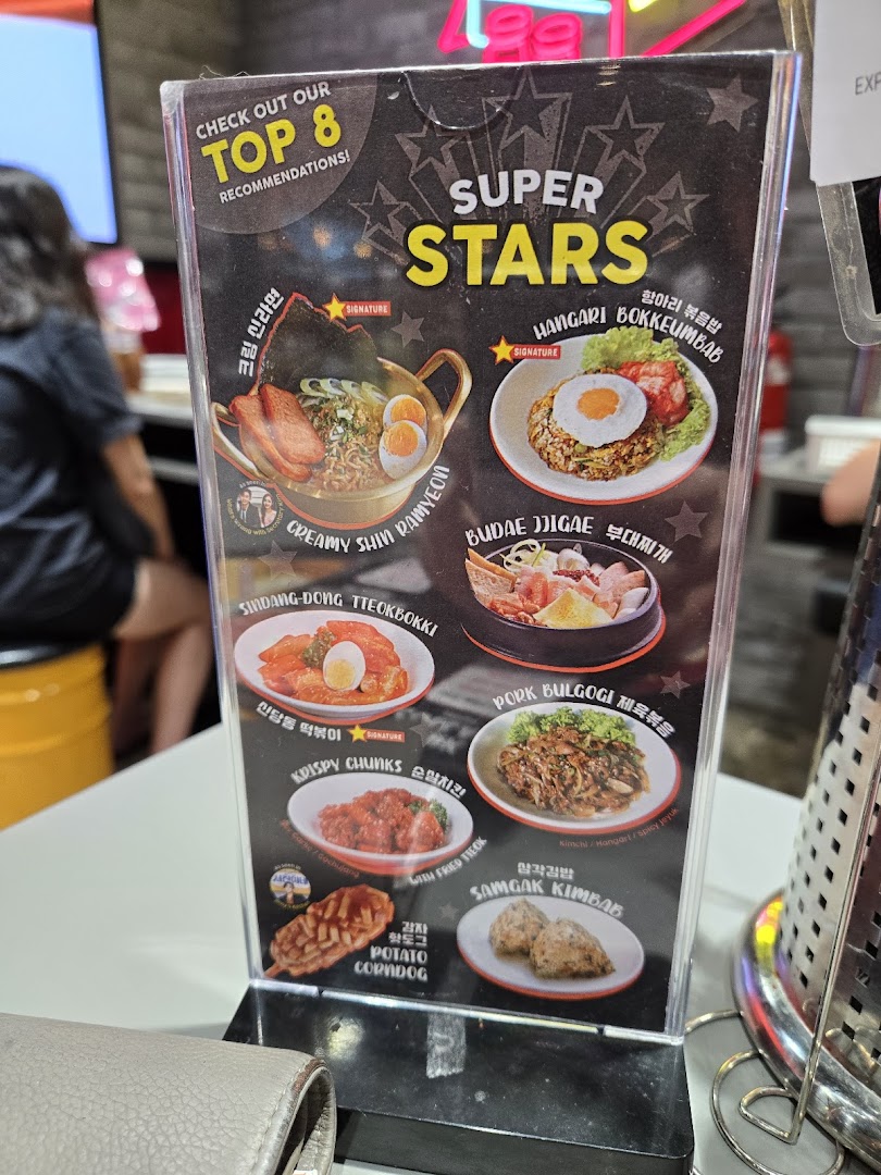 A tabletop menu display showcasing POCHA!'s 'Top 8 Recommendations' of popular Korean street food and dishes.