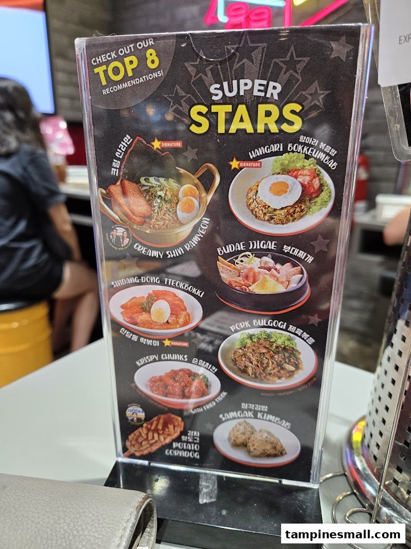 A tabletop menu display showcasing POCHA!'s 'Top 8 Recommendations' of popular Korean street food and dishes.