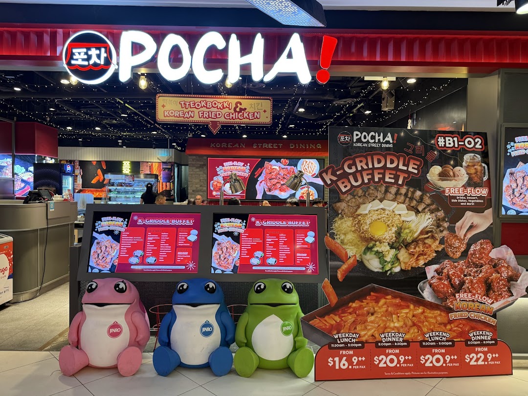 The vibrant storefront of POCHA! Korean Street Dining, featuring promotional displays for K-Griddle Buffet and cute frog mascots.