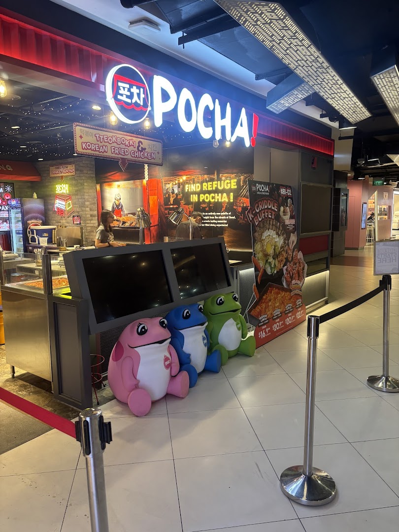The vibrant shopfront of POCHA! Korean Street Dining, featuring its signage, buffet poster, and frog mascots.