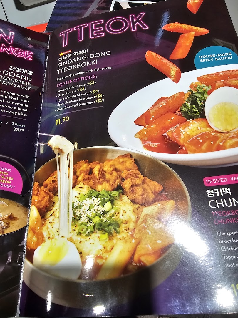 A vibrant menu page showcasing Korean Tteokbokki with various toppings and a cheesy fried chicken dish.