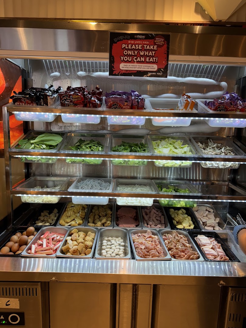 A vibrant self-service display showcasing a wide variety of fresh ingredients for customizable Korean street food.