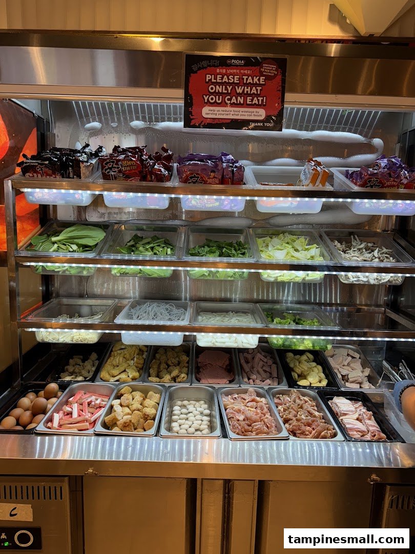A vibrant self-service display showcasing a wide variety of fresh ingredients for customizable Korean street food.