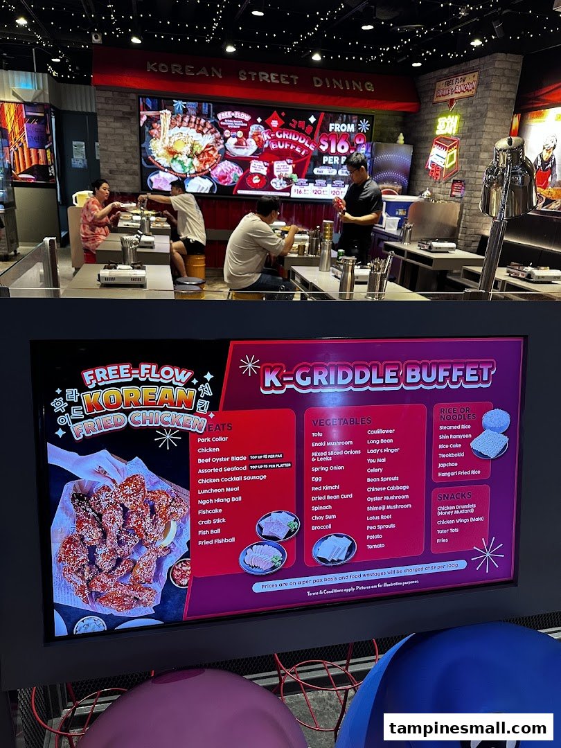 Interior view of POCHA! Korean Street Dining, featuring a digital menu board for K-Griddle Buffet and Free-Flow Fried Chicken.