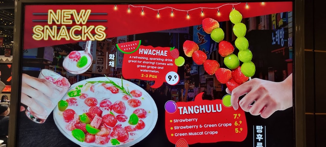 A digital menu board showcasing new Korean snacks, Hwachae and Tanghulu, with prices and descriptions.