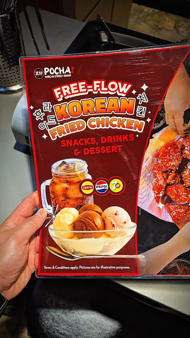 A promotional sign for POCHA! Korean Street Dining, highlighting a free-flow Korean fried chicken offer.