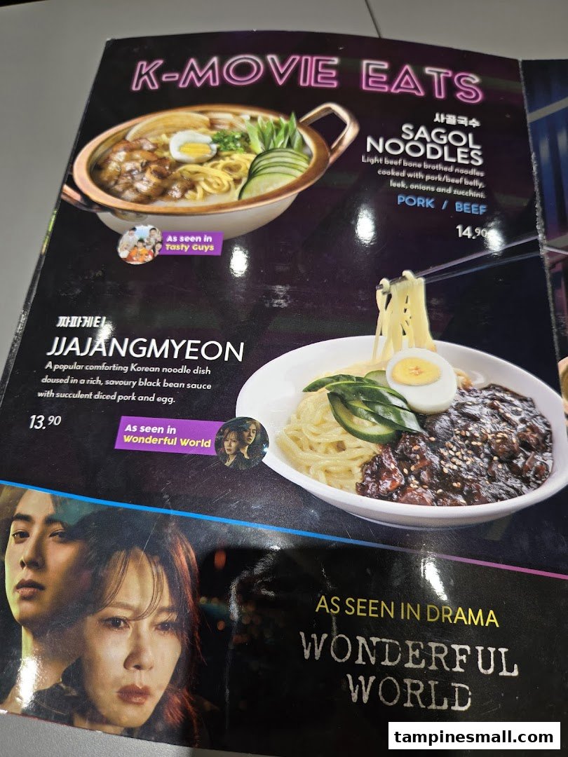 A menu page featuring K-Movie Eats, including Sagol Noodles and Jjajangmyeon, with prices and descriptions.
