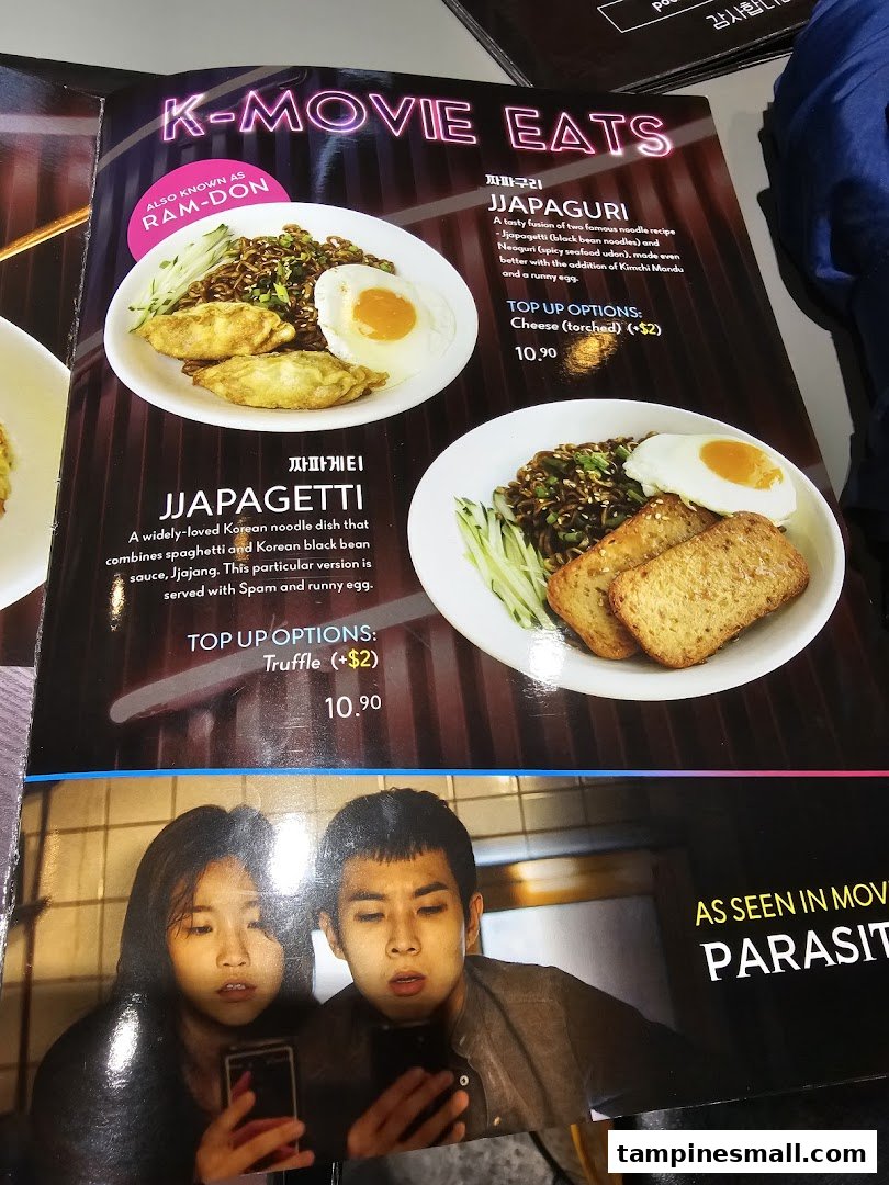 A menu page featuring K-Movie inspired Korean noodle dishes like Jjapaguri and Jjapagetti with prices and descriptions.