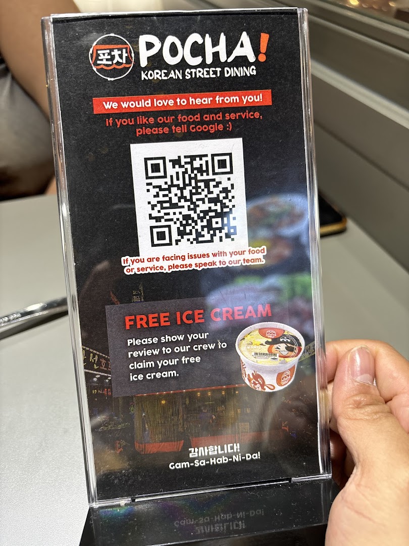 A table-top stand from POCHA! Korean Street Dining, offering free ice cream for customer reviews.