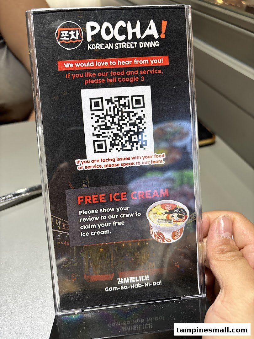 A table-top stand from POCHA! Korean Street Dining, offering free ice cream for customer reviews.