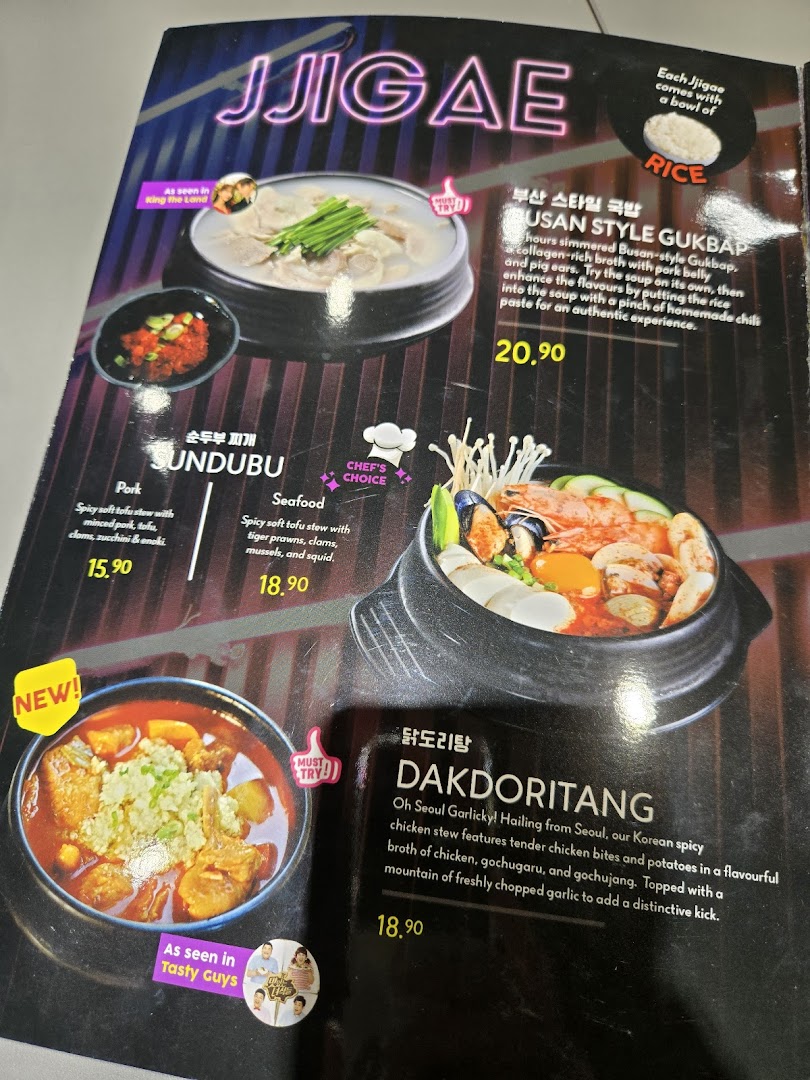 A vibrant menu page showcasing various Korean stews and hotpots with descriptions and prices.
