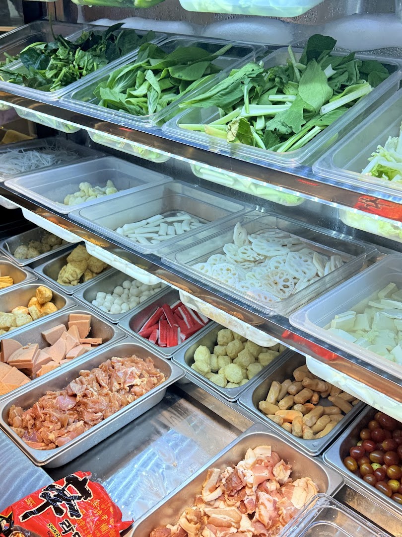 A vibrant display of fresh ingredients for custom Korean street dining dishes.