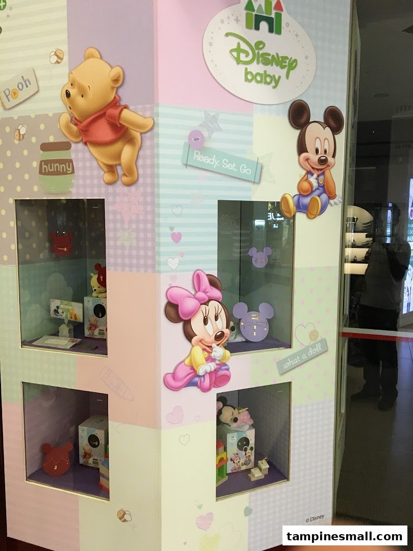 A colorful display stand featuring Disney Baby characters like Winnie the Pooh, Mickey, and Minnie Mouse.