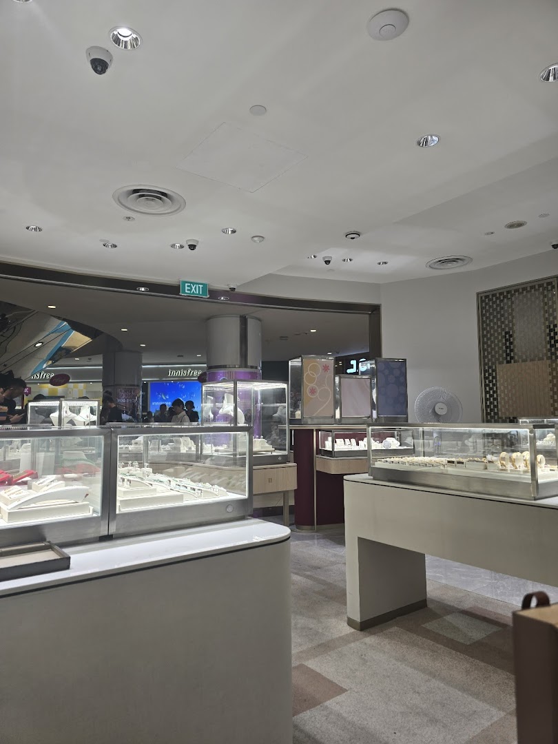 Interior view of Poh Heng Jewellery, showcasing brightly lit display cases filled with exquisite jewelry.
