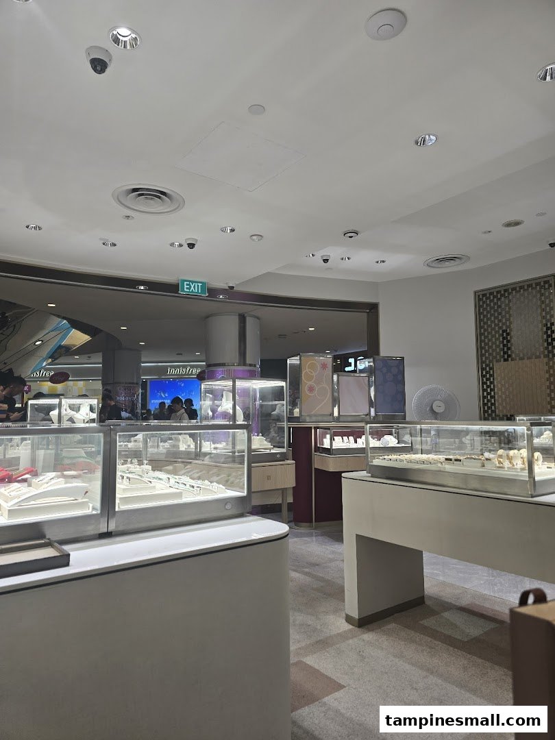 Interior view of Poh Heng Jewellery, showcasing brightly lit display cases filled with exquisite jewelry.