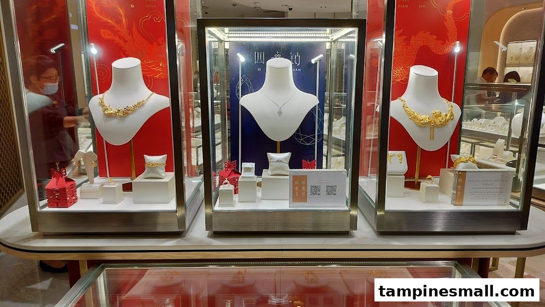 Three illuminated display cases showcase intricate gold and diamond jewelry pieces, including necklaces and rings.