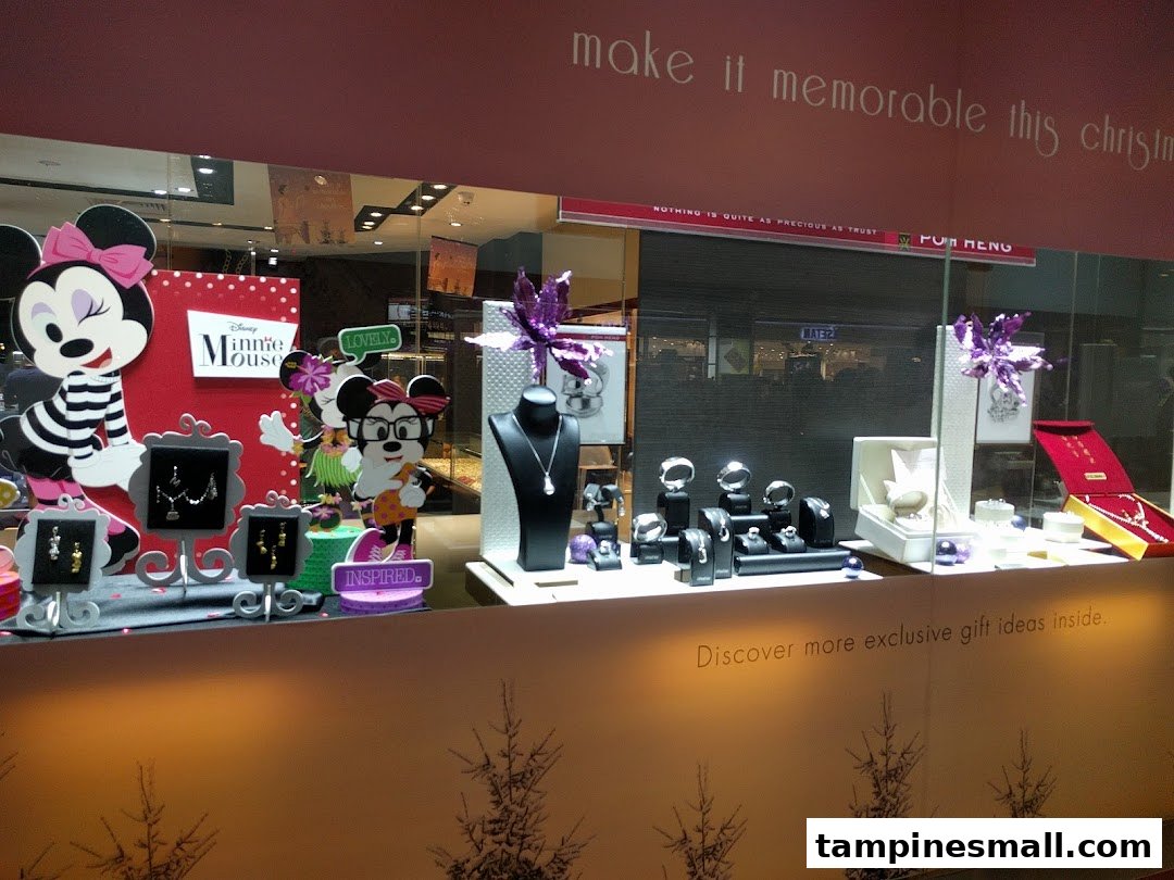 A festive jewelry shop window display featuring Disney Minnie Mouse characters and elegant pieces.