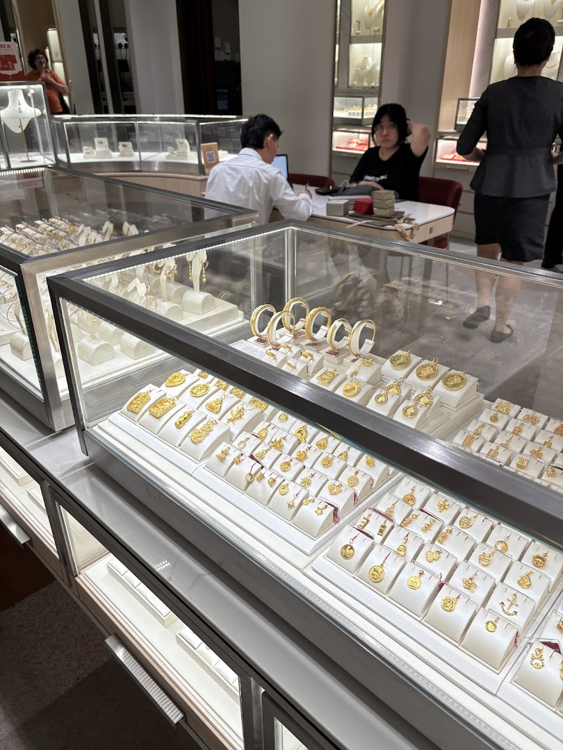 Interior view of Poh Heng Jewellery, showcasing display cases filled with exquisite gold jewellery and staff.