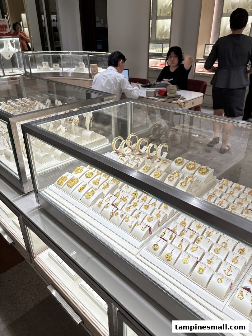 Interior view of Poh Heng Jewellery, showcasing display cases filled with exquisite gold jewellery and staff.