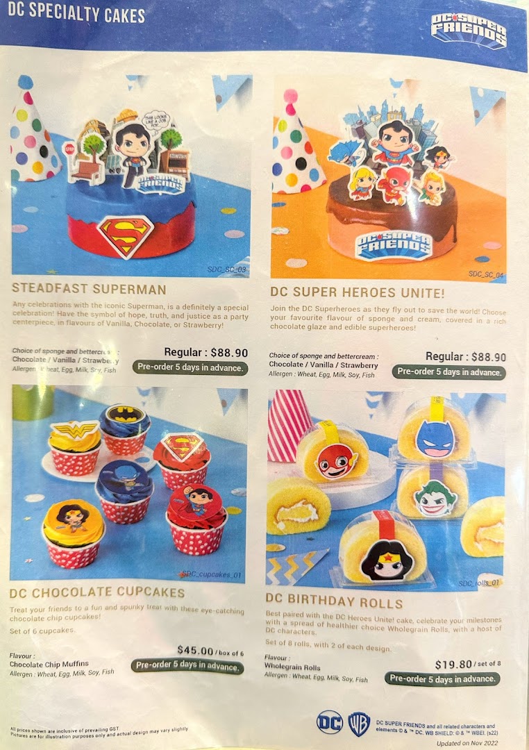 A menu displaying various DC Comics themed specialty cakes, cupcakes, and birthday rolls.