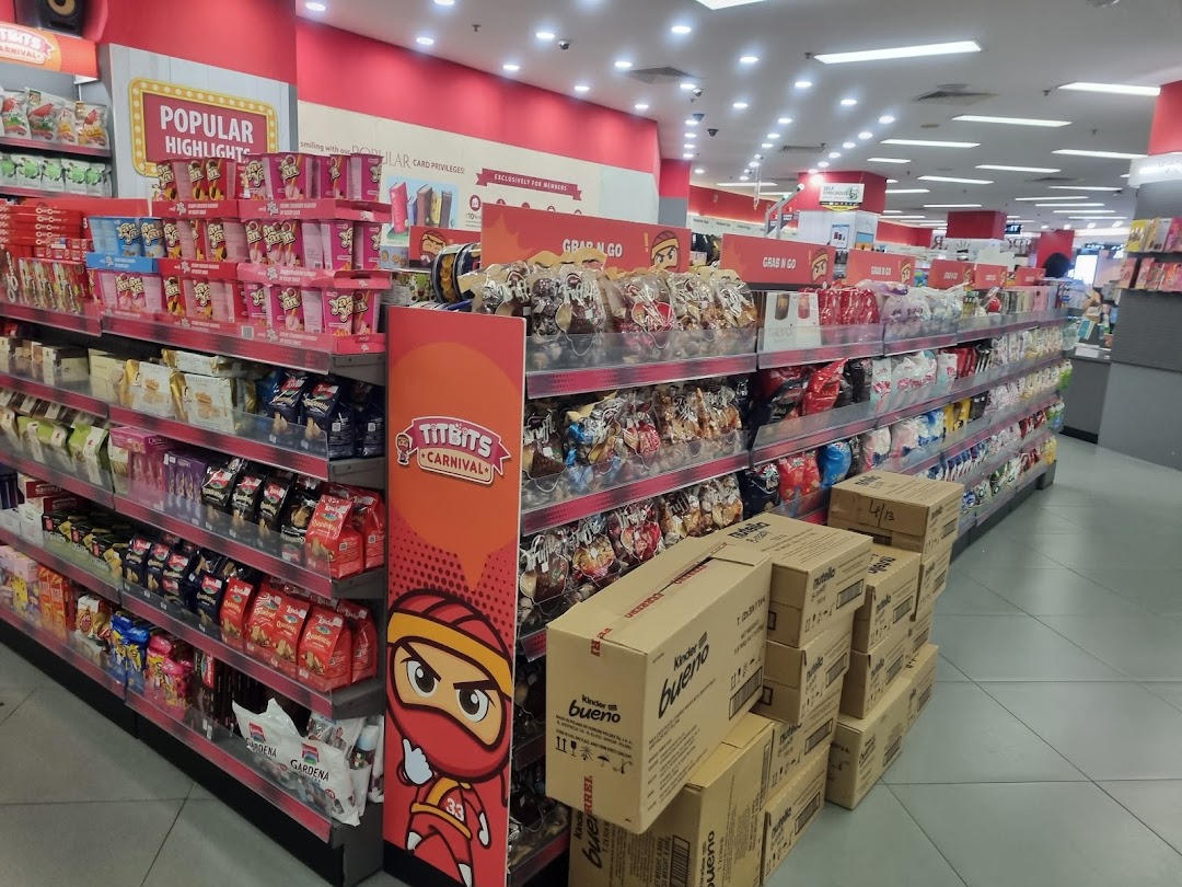 An aisle inside a bookstore featuring a wide selection of packaged snacks and treats.