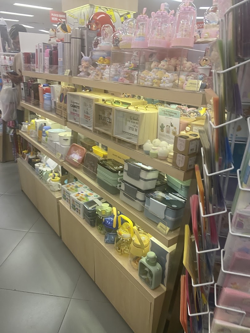 Shelves displaying a wide array of stationery, gifts, and lifestyle products within a bookstore.
