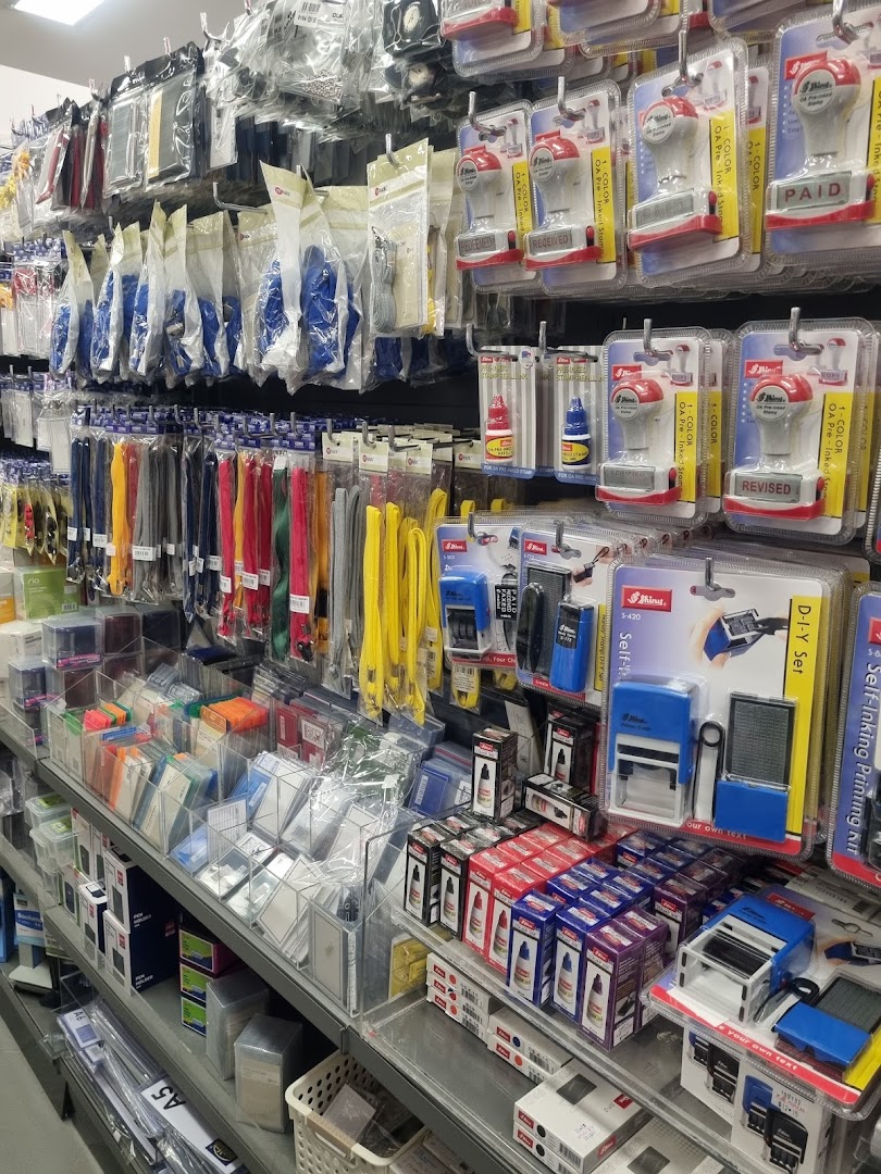 Shelves filled with office supplies like stamps, ink, and lanyards in a bookstore.