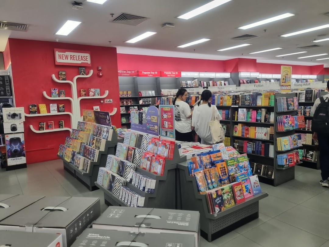 Interior of POPULAR Bookstore with shelves of books, displays, and customers browsing.