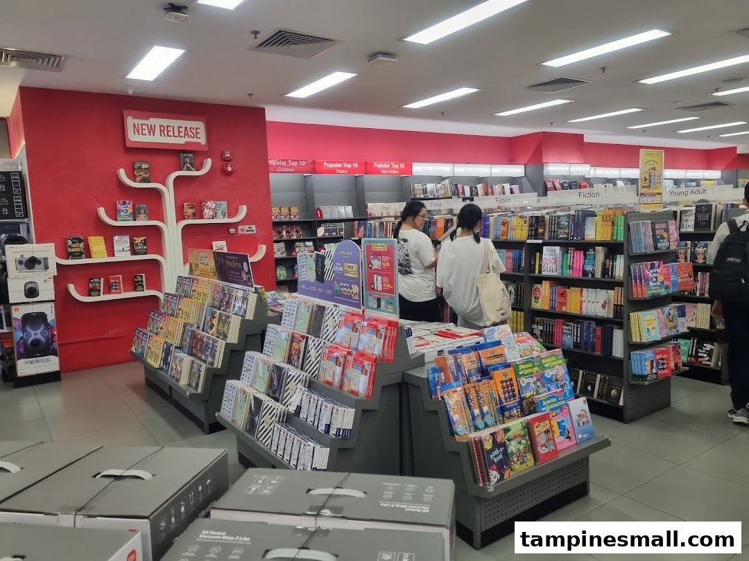 Interior of POPULAR Bookstore with shelves of books, displays, and customers browsing.