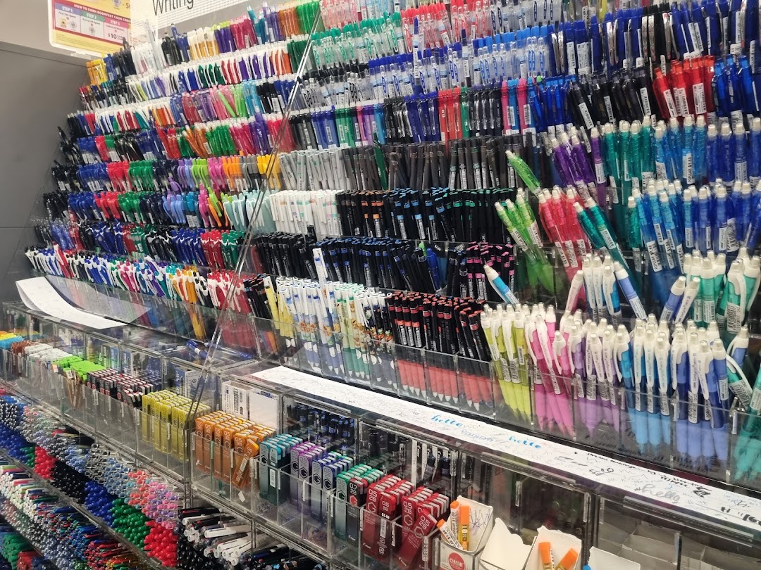 A vibrant display of colorful pens and writing instruments in a bookstore.