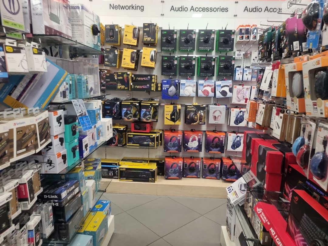 An aisle showcasing diverse electronics, audio accessories, and networking products at POPULAR Bookstore.