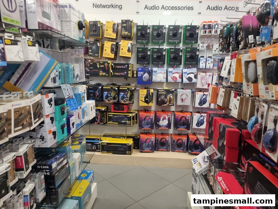 An aisle showcasing diverse electronics, audio accessories, and networking products at POPULAR Bookstore.