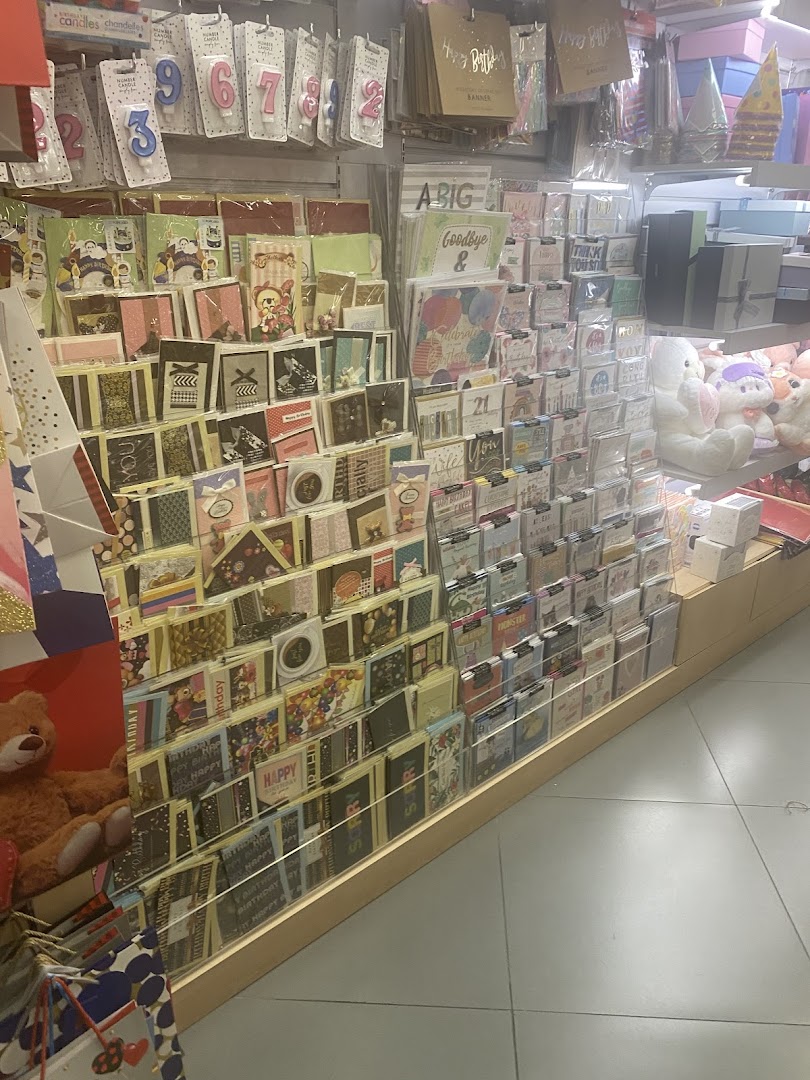 Interior view of a bookstore displaying greeting cards, birthday candles, and gift items.