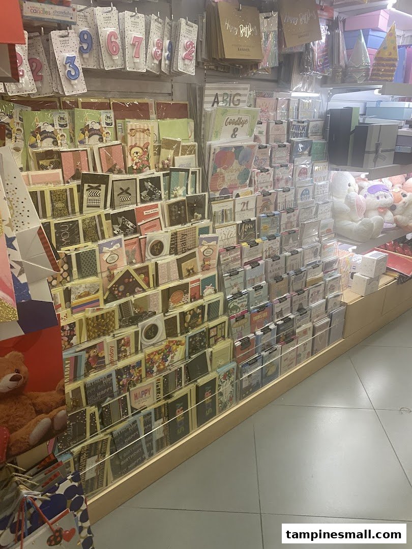 Interior view of a bookstore displaying greeting cards, birthday candles, and gift items.