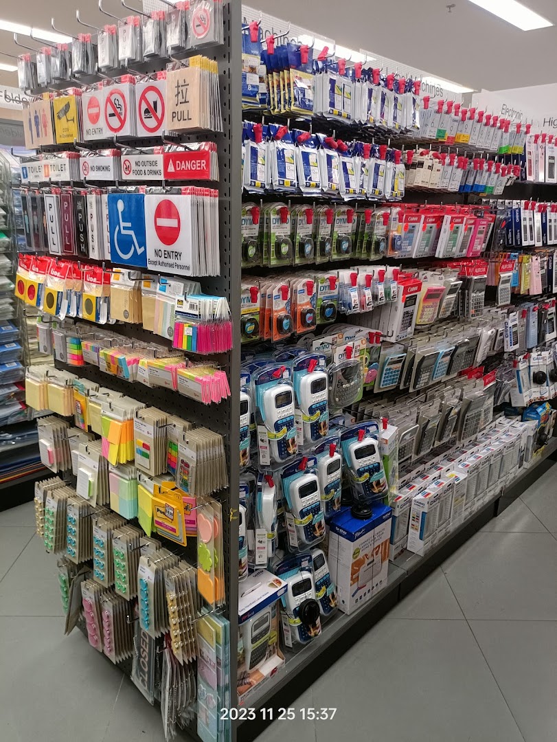 An aisle in POPULAR Bookstore displaying a wide range of stationery, signs, calculators, and office supplies.
