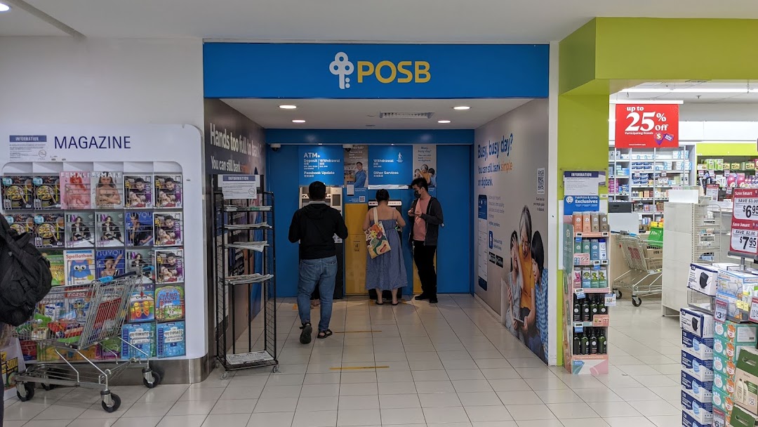 Customers utilize the POSB ATM and banking services area inside a bustling shopping mall.