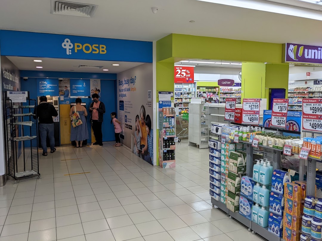 People using POSB ATMs next to a supermarket aisle with various products and promotions.