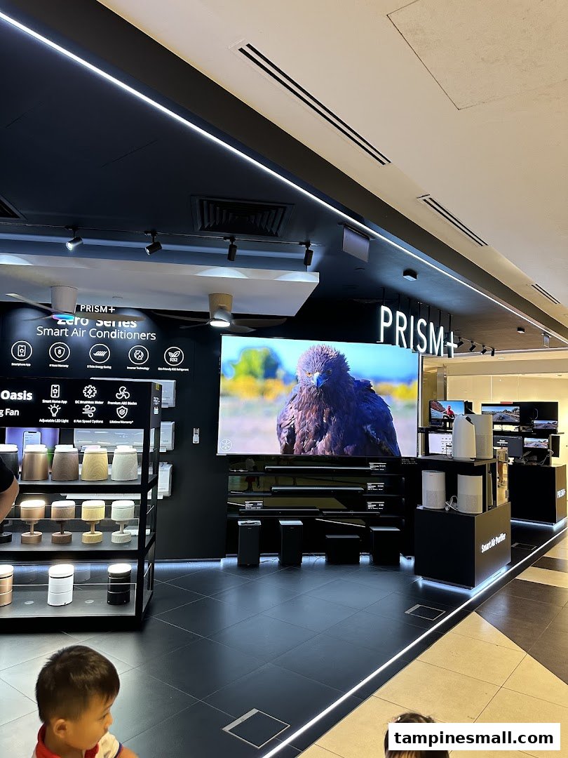 Interior view of PRISM+ store showcasing smart air conditioners, large screen TVs, and air purifiers.
