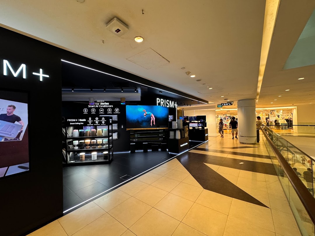 Modern PRISM+ shopfront at Tampines Mall showcasing smart home appliances and large display screens.