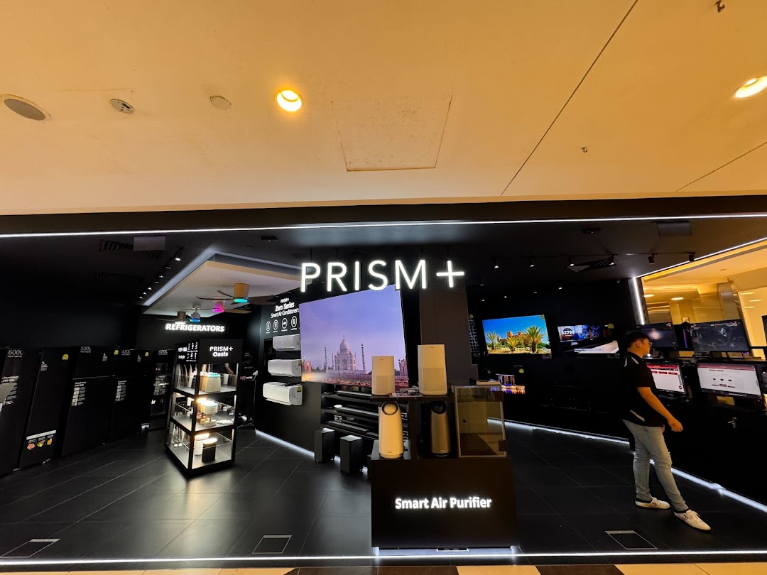 The storefront of PRISM+ electronics store, showcasing home appliances and large displays.