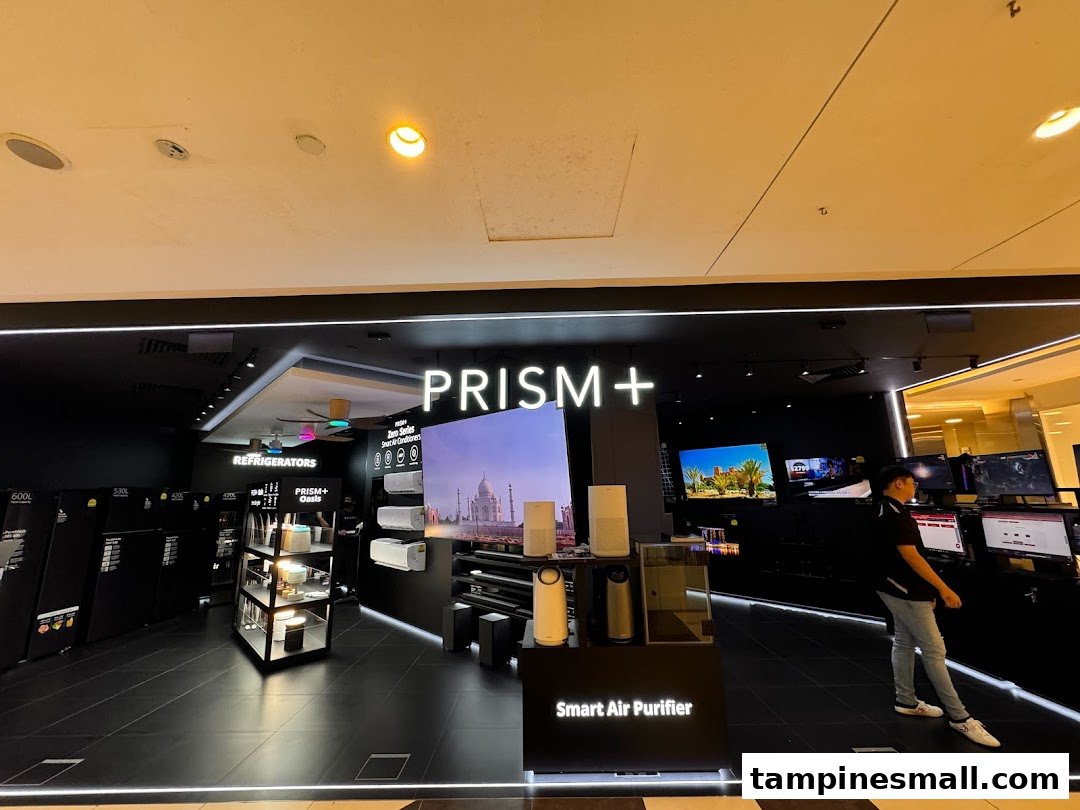 The storefront of PRISM+ electronics store, showcasing home appliances and large displays.