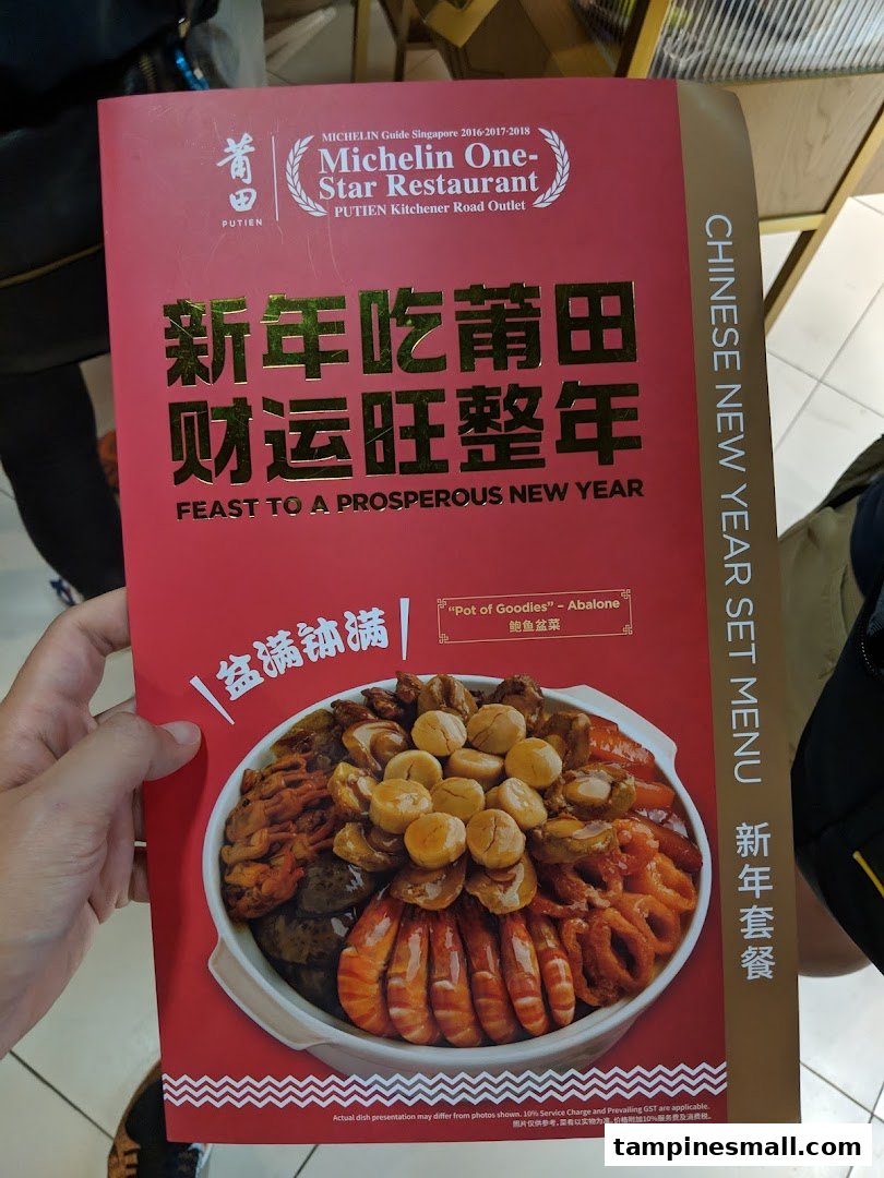 A hand holds a PUTIEN Chinese New Year set menu flyer featuring a 'Pot of Goodies' dish.