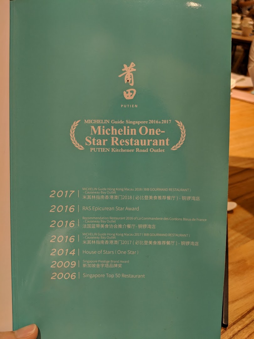A page showcasing PUTIEN's prestigious restaurant awards and accolades, including Michelin recognition.