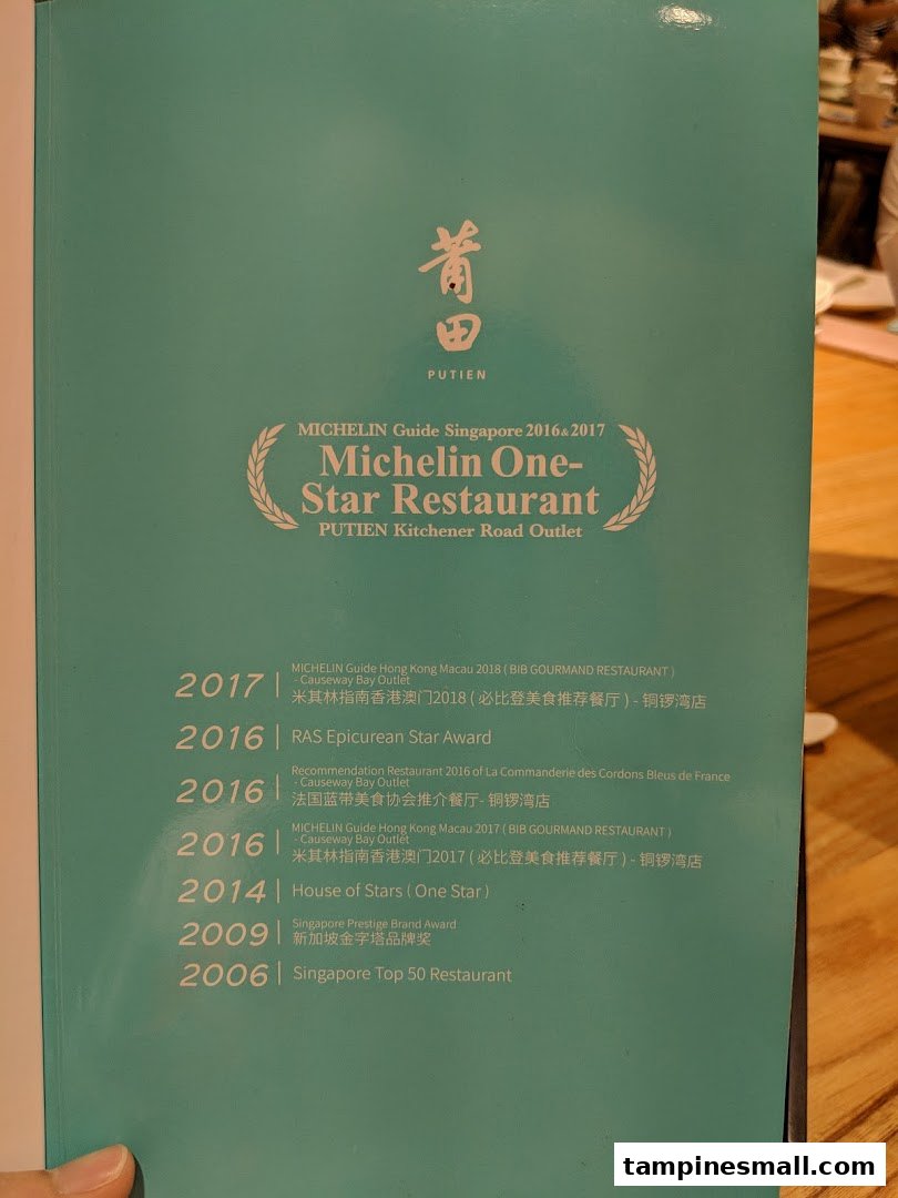 A page showcasing PUTIEN's prestigious restaurant awards and accolades, including Michelin recognition.