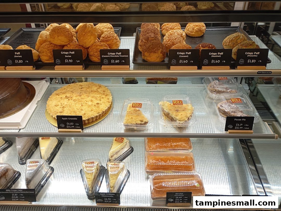 A vibrant display case showcasing a variety of freshly baked pastries, strudels, and pies at Ritz Apple Strudel.