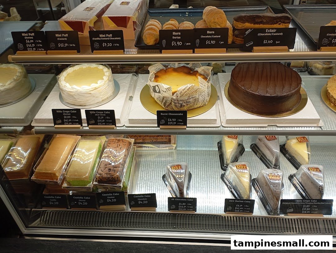 A vibrant display case showcasing a variety of delicious cakes, pastries, and puffs.
