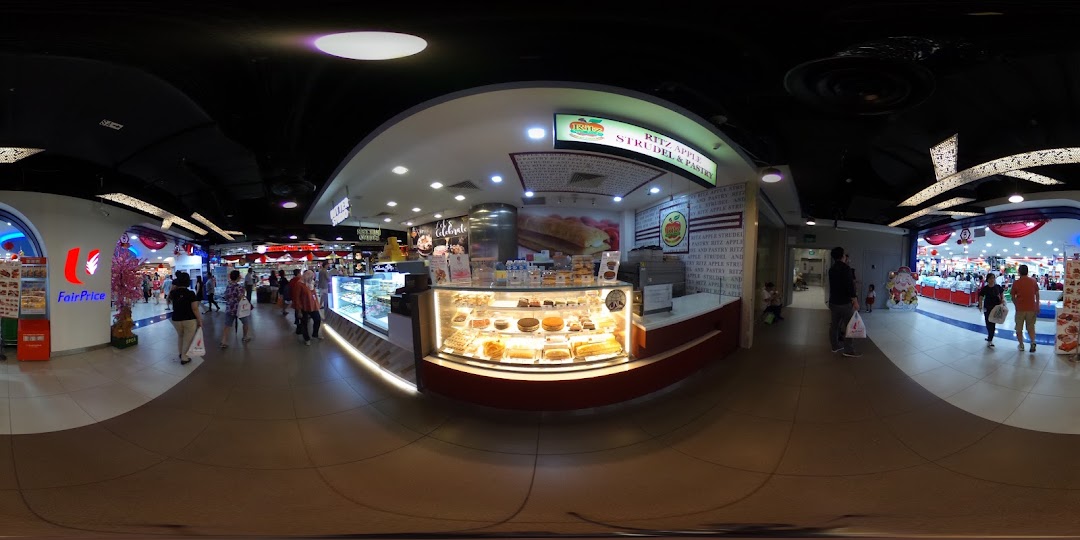 A panoramic view of Ritz Apple Strudel's display counter within a bustling mall environment.