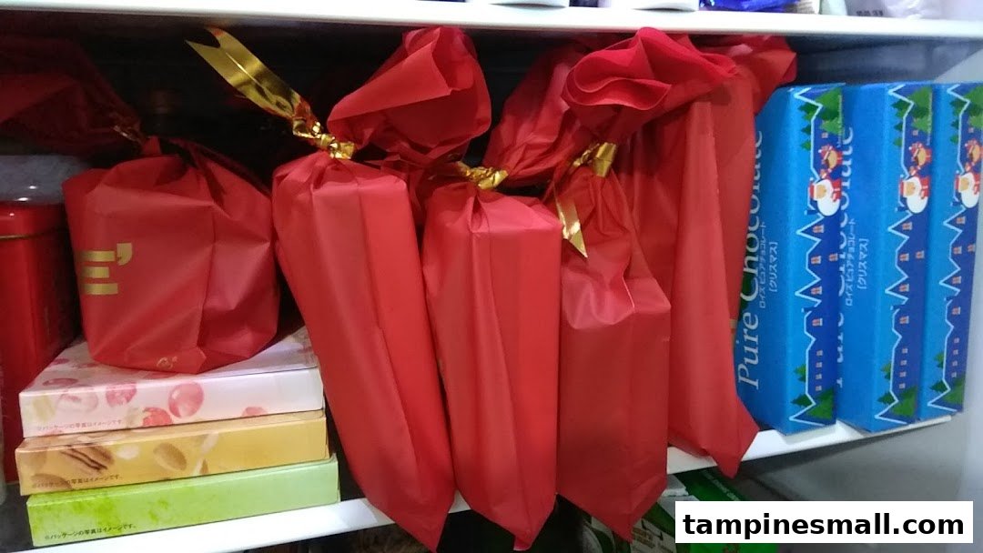 A shelf displaying red gift-wrapped chocolates and blue Christmas-themed Pure Chocolate boxes from Royce.