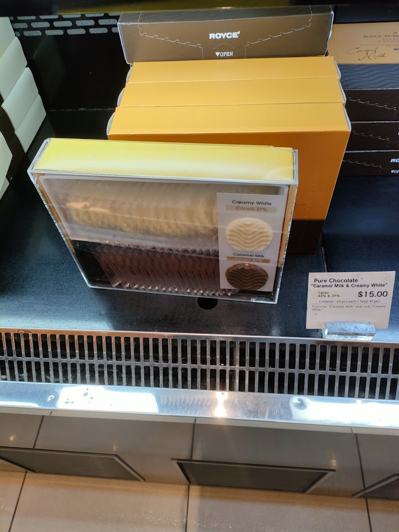 A display of Royce's Pure Chocolate, featuring Caramel Milk and Creamy White varieties with pricing.